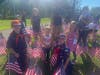 A crowd turned out and placed 2,977 flags to remember the lost on 9/11.