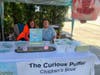 Claire Kennedy of Southold and her son Ian Hunter signing copies of their book "The Curious Puffer." 