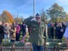 The crowd stood in solemn respect Thursday.