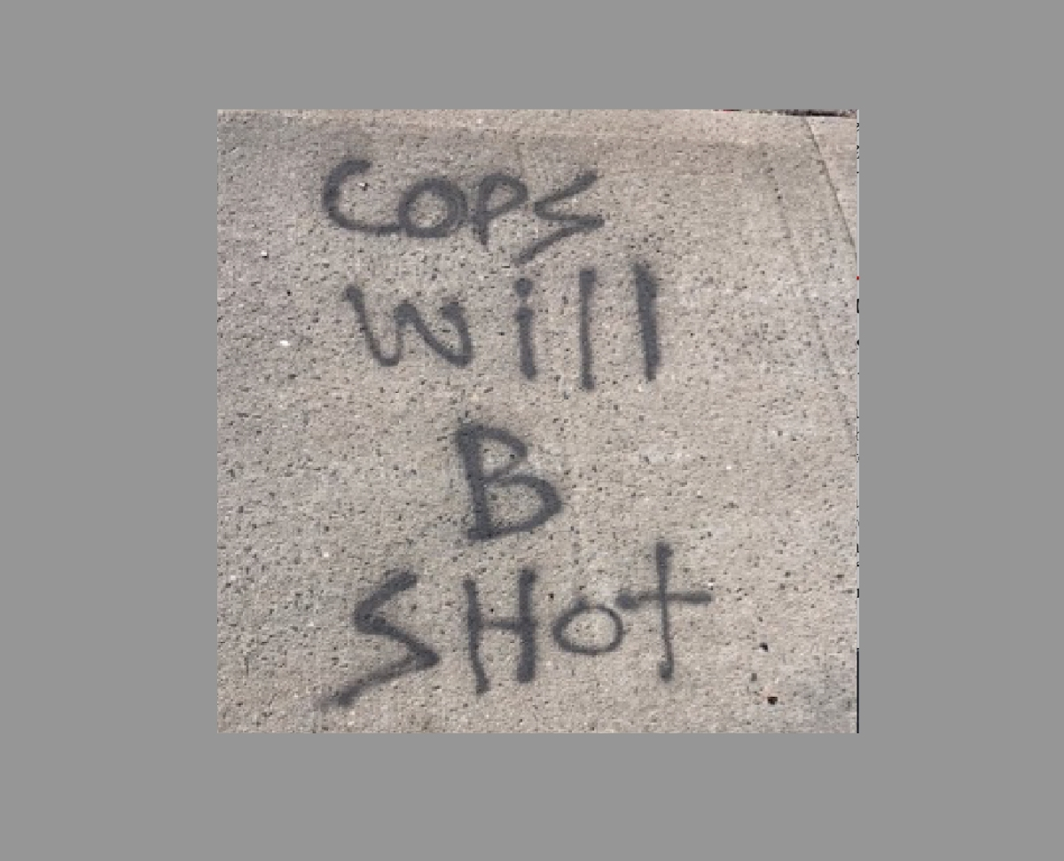 The graffiti included threats to police and their families, authorities said.