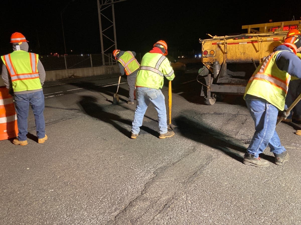 New York State Department of Transportation workers repairing potholes on Sunrise Highway.
