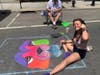 Artists used brightly colored chalk to create their paintings.