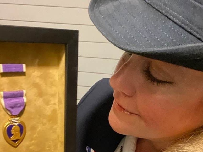 Lisa Dabrowski with the Purple Heart medal found at a North Fork yard sale. On Sunday, after a series of miracles, the medal will be reunited with the hero's daughter, who never knew it existed.