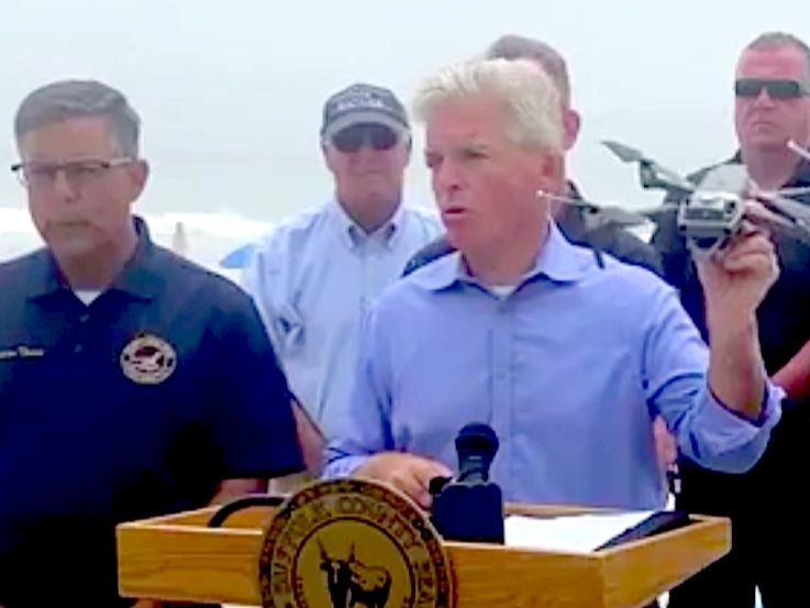 Suffolk County Executive Steve Bellone displays one of the drones used to keep waters safe after three shark bites were reported in local waters over the past 10 days.