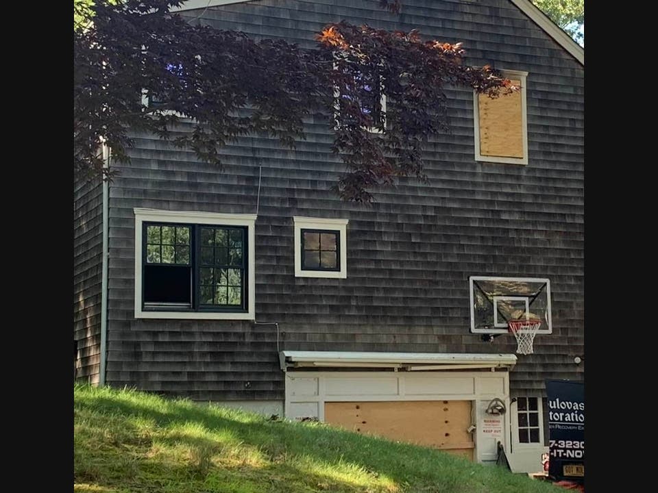 The home, sited behind thick hedges was visibly damaged in the deck area, and had boarded-up windows after the tragedy.