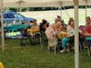 Those gathered enjoyed picnic fair in the sunshine.
