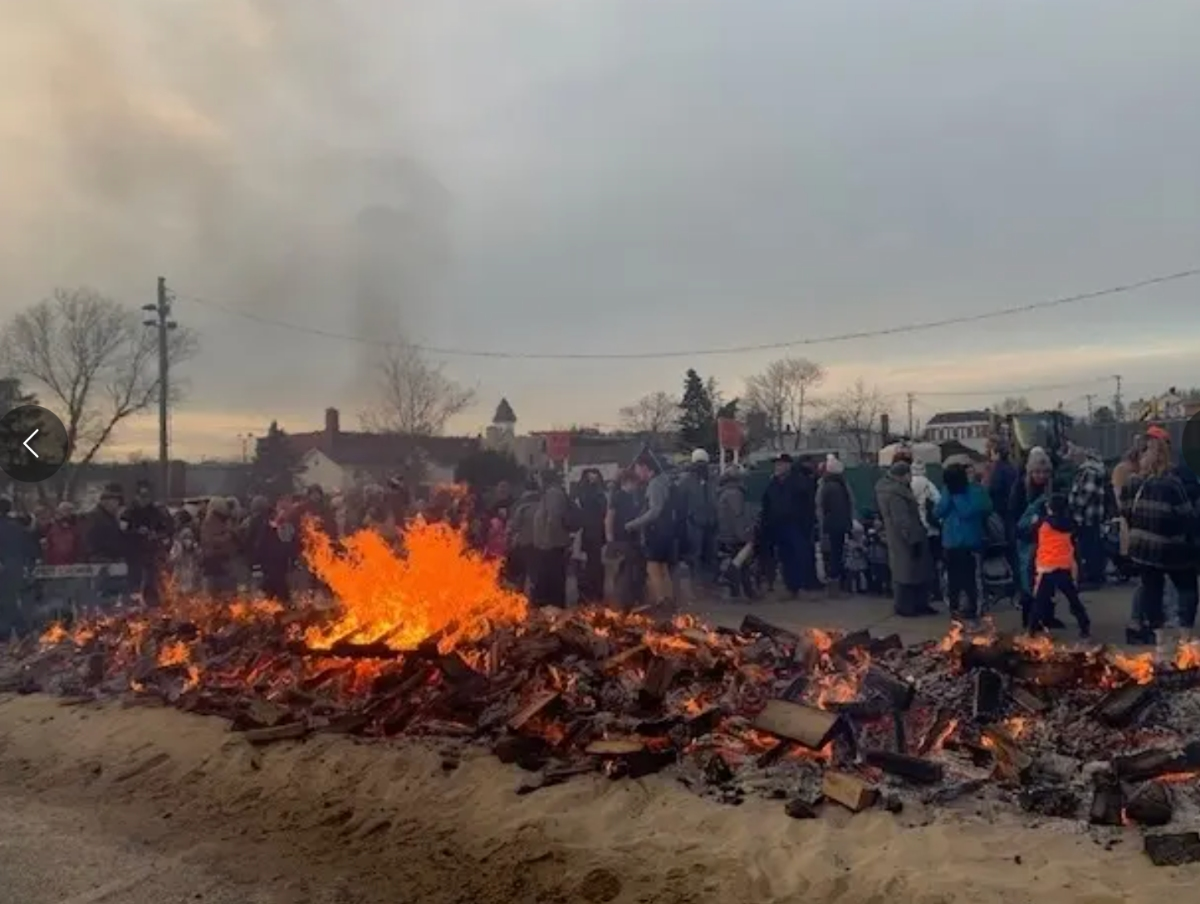 The bonfire keeps the crowd warm at a past event.
