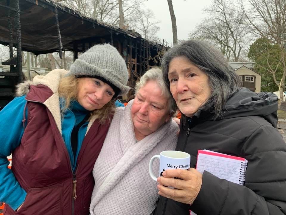 Katie Polk (left) and her neighbors after a devastating fire Saturday.