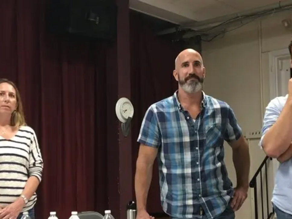 Members of the Brinkmann family at a civic meeting where the public blasted the plan for a hardware store.