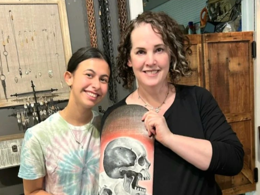 Rena Wilhelm with a young artist and her deck. The kids inspire all her dedicated efforts to reinvigorate the skate park, Wilhelm said.