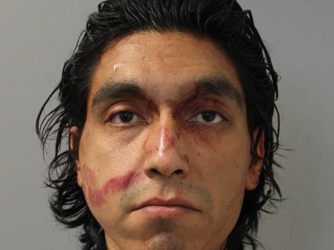 He slashed multiple people with a razor blade as they struggled to prevent him from getting inside of the house, the DA said.