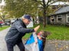 Greenport Village Mayor Kevin Stuessi and a young superhero.