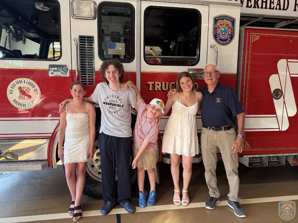 Robert "Bobby" Szczepanik and his family at a ceremony last week marking 50 years of service.