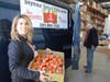 Griffin Health Director of Population Health Monica Oris loads up a van for the Oxford-Seymour Food Bank with a box of fresh tomatoes.