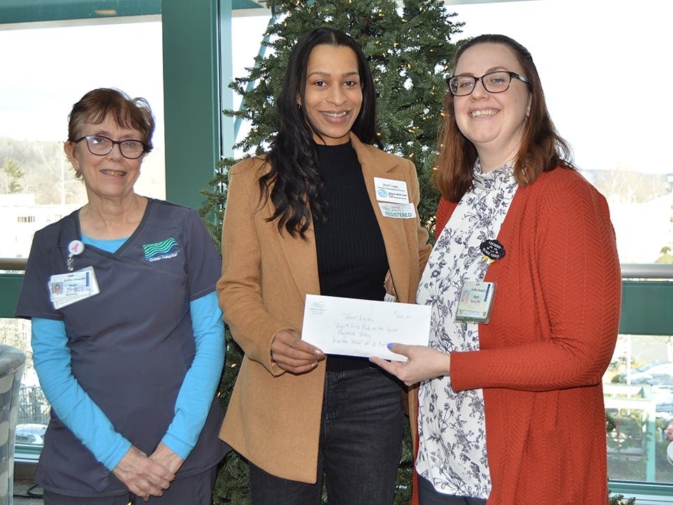 Griffin Hospital Unit Clerk Ruth Tuccio, left, and April Garcia, BSN, RN, Clinical Nurse Manager for Griffin Hospital 2 North A, right, presented a $700 donation to Jewel Logan, Assistant Development Director for the Boys & Girls Club.