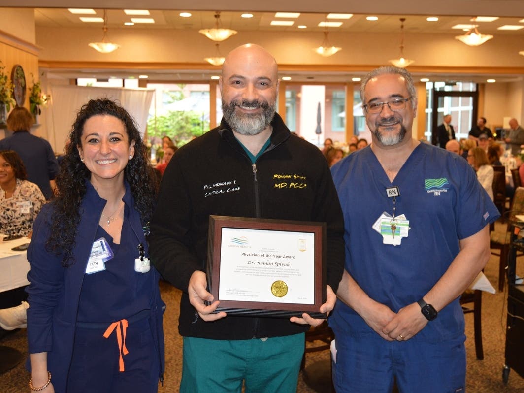 Pulmonologist Dr. Roman Spivak, center, received the Physician of the Year Award from Griffin Health Clinical Nurse Educator Ashley D'Agostino-Putetti, MSN, RN, WCC, and Critical Care Unit Clinical Manager Edward Valente, RN, BSN, CCRN.