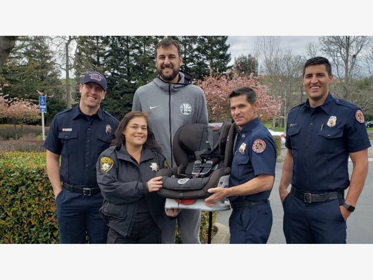 Golden State Warriors player Andrew Bogut visited the San Ramon Police Department to get help installing a car seat.