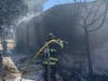 The flames spread to a nearby storage complex, according to fire officials.