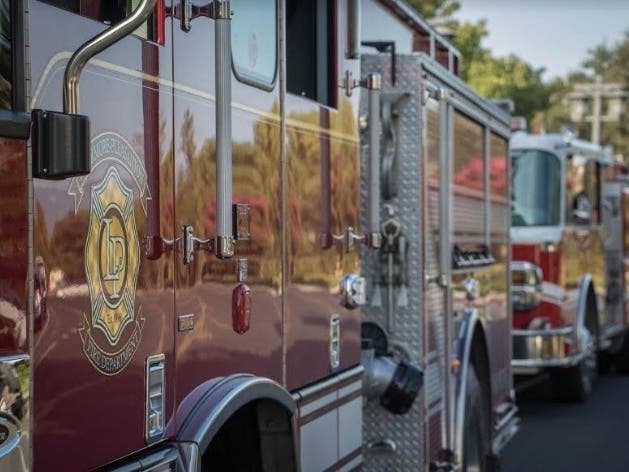 The area is populated with commercial buildings and nearby housing.