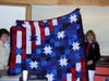Jeaneen Buchanan and Marion Osborne holding Quilt of Valor