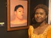 Lydia Wooden standing with her artwork