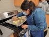 A Bremen High School culinary student works on final touches to her cupcakes for "Bake Off"