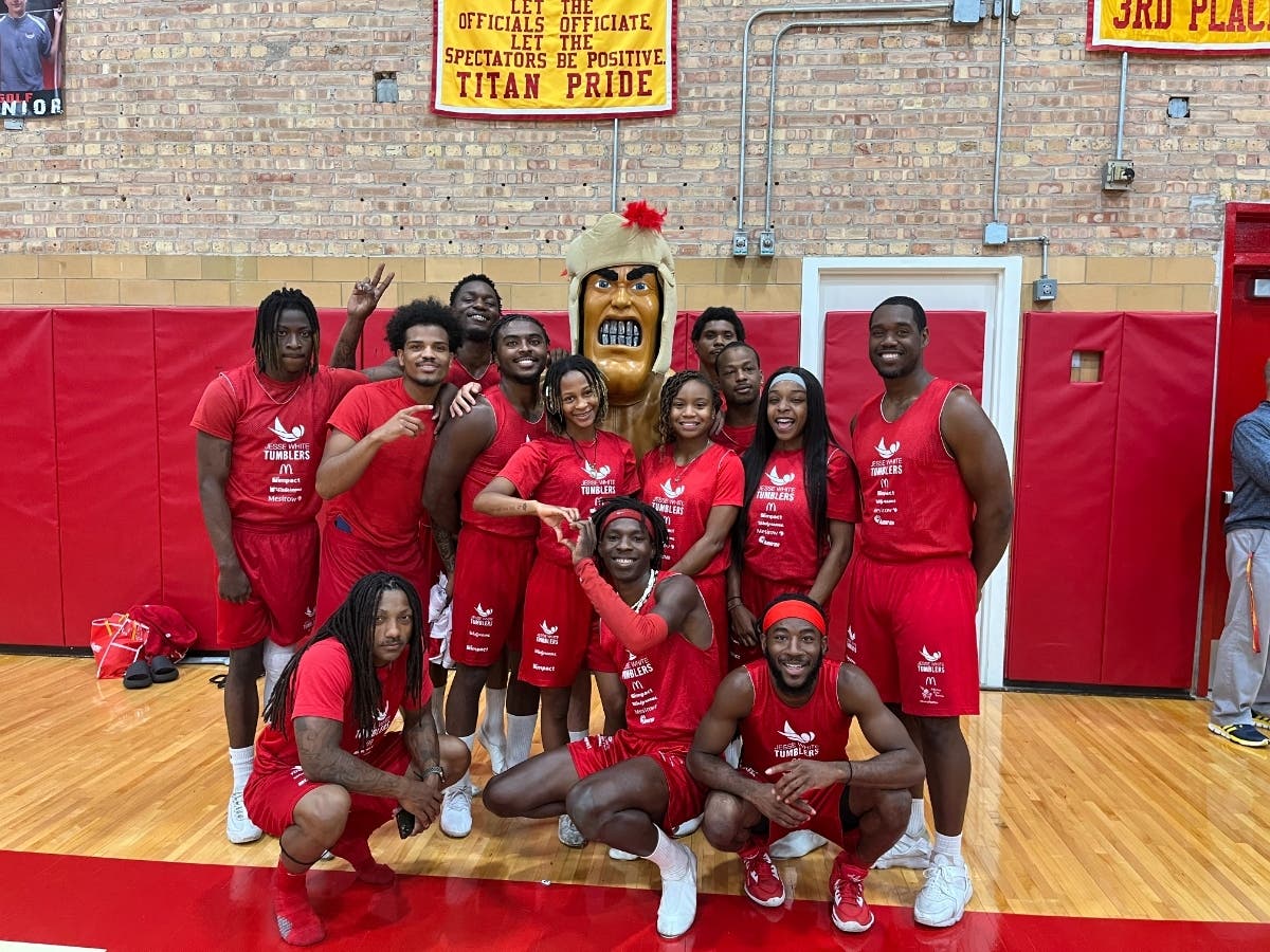 The Jesse White Tumblers pose with Timmy the Titan at Tinley Park High School on September 13, 2023.