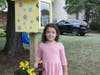 Eloisa Coelho, age 6, stands by the Little Free Library at 1604 Cedar Park Road. 