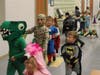 Children in their Halloween costumes parade around Germantown Elementary School’s cafeteria.