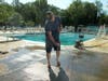 Jonathan VerMerris uses a power washer to clean the deck at the Admiral Heights Swim Club.