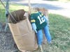 A scarecrow leans against some “to-go” bags. These bags will be delivered or picked up by Admiral Heights neighbors who didn’t attend the scarecrow making event.