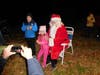 Lilly Garcia and her brother, William, pose with Santa while their dad, Grant Garcia, takes photos. 