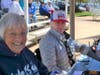 This photo shows Mitzi Hines (blue hoodie) and Erika Gable (hat) scoreboard; team up to keep things straight during game action at North Shore Park. With husbands on the playing field their volunteer effort is a family event. 