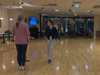 Brianna works with students on the dance floor, bringing enthusiasm and focus to every dance lesson.