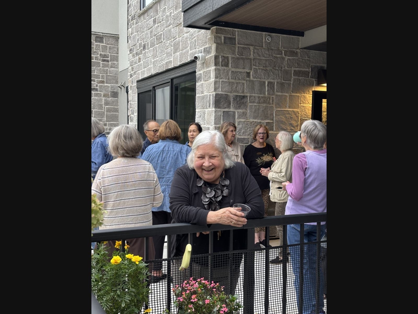 Gayle Maurin, 75, poses for a picture with her friends/neighbors at the 55+ community where she lives: The Fieldston of Fairway.
