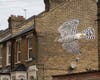 The London-based artist known as ATM painted this large image of a sparrowhawk on the side of a building on Daubeney Road in London.