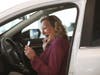 Kathy Miller delights as she starts the engine of her new Honda.