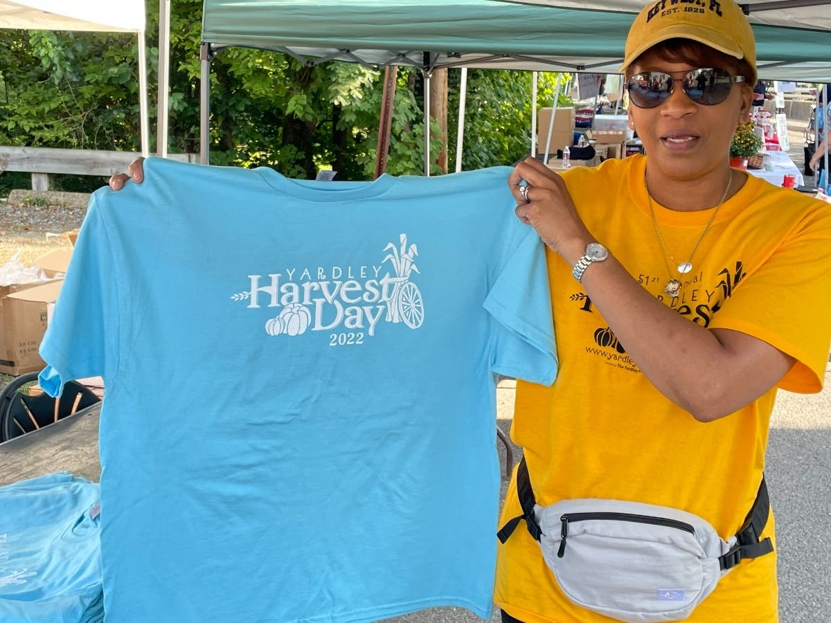 Harvest Day committee member Tracey Walker showcased this year's T-shirts at a booth Saturday.