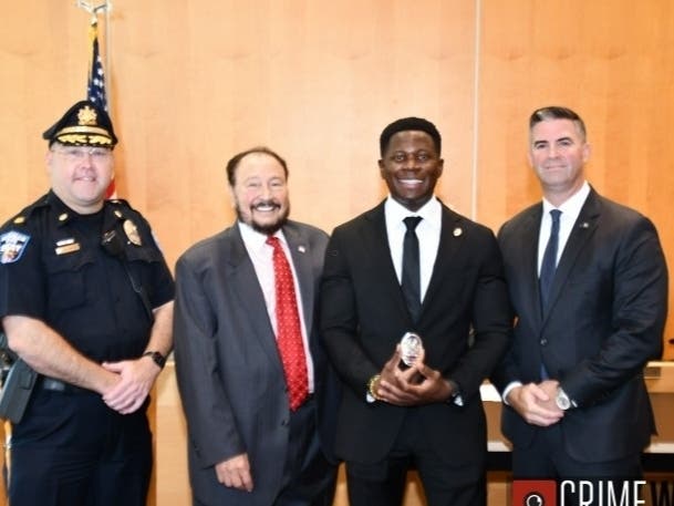 New Bensalem Township police officer Alex Agyedu​ poses with Mayor Joseph DiGirolamo and Director of Public Safety William McVey Friday.