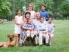 Reed is pictured with her husband and six children.