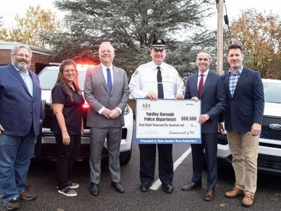 Yardley Borough Police Chief Joseph Kelly III accepts a $68,600 check to replace an aging police car.