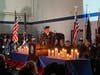 Horsham Township Police Chief Scott Fida is surrounded at the podium by candles lit for Montgomery County's fallen law enforcement.