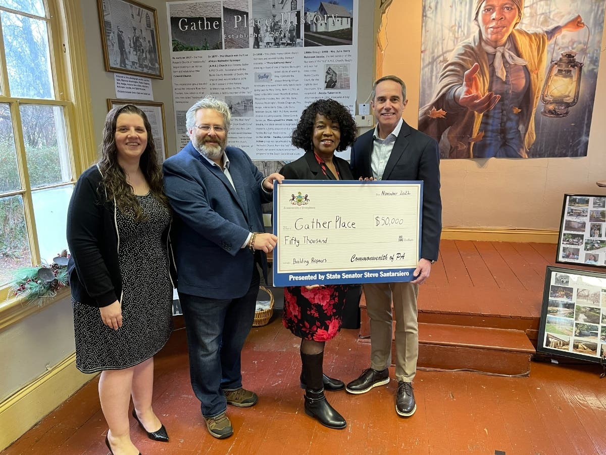 Gather Place Executive Director Shirley Lee Corsey receives a $50,000 check from State Sen. Steve Santarsiero. They were joined by Yardley Councilman David Appelbaum.