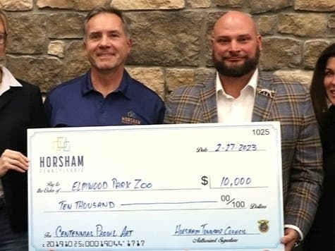 Horsham Township presented a $10,000 check to the Elmwood Park Zoo for a jaguar sculpture to be installed in front of the library.