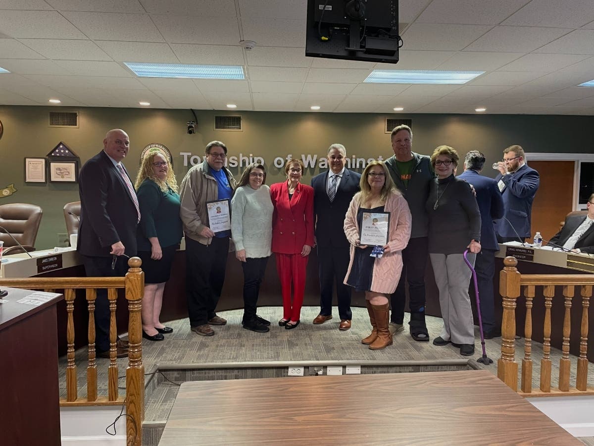 Winners of Warminster's first holiday home decorating contest pose with township supervisors at Thursday night's meeting.