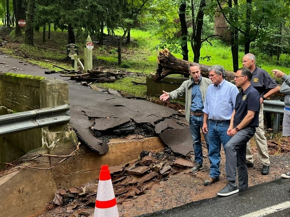 Gov. Josh Shapiro is joined by State Sen. Steve Santarsiero to witness the damage caused from flash flooding Saturday afternoon in Upper Makefield Township that claimed the lives of five people.