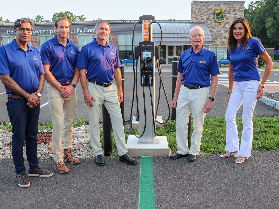 Horsham Township Council poses with a charging station for electric vehicles that is located at the Horsham Municipal Complex on Horsham Road.