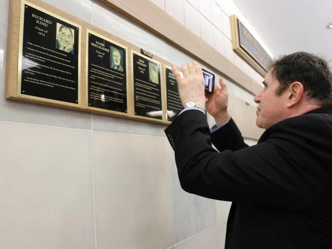 Actor Richard Kind, Pennsbury High School Class of 1974, snaps a photo of his plaque
on the Pennsbury High School Hall of Fame. He was a 2022 Hall of Fame inductee.