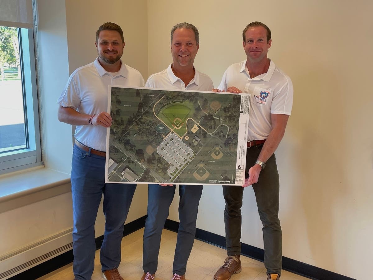 Treasurer Erick Goodwin, left, Board President William Slaymaker and Councilman Sean Wade hold up the map for the Miracle Field of Horsham.