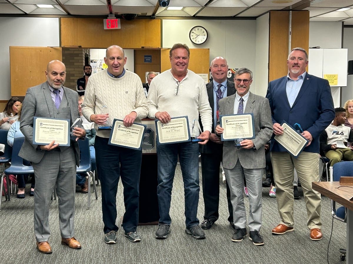 Bensalem School Director Marc Cohen, second from right, holds a certificate for his school board service. But Cohen will be continuing on the board after being appointed to an open seat.